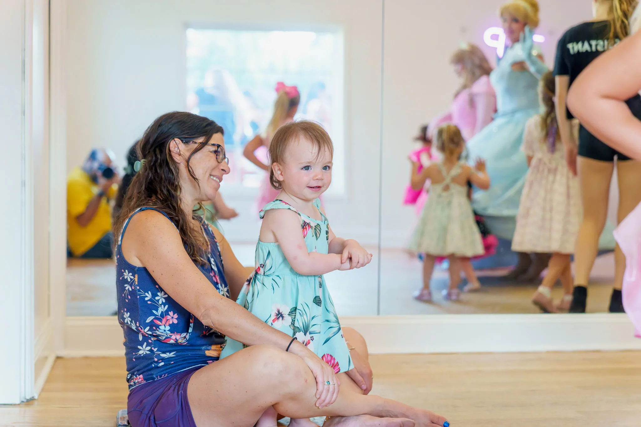 A KICK teacher dancing with toddlers in a caregiver-and-me class